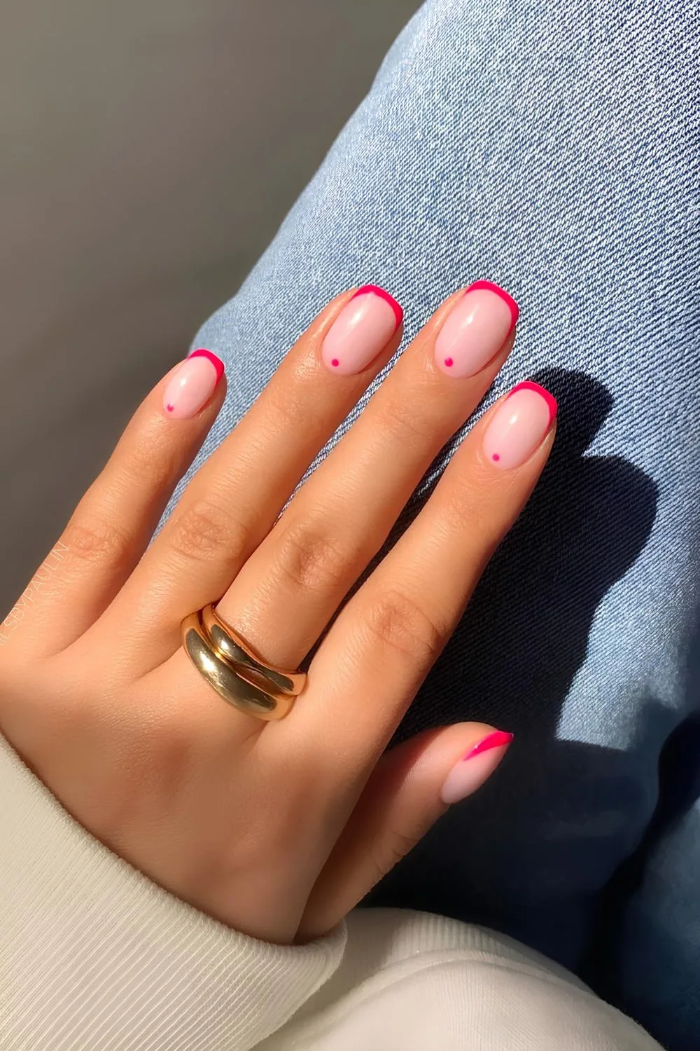 Pink French tip nails with dot accents