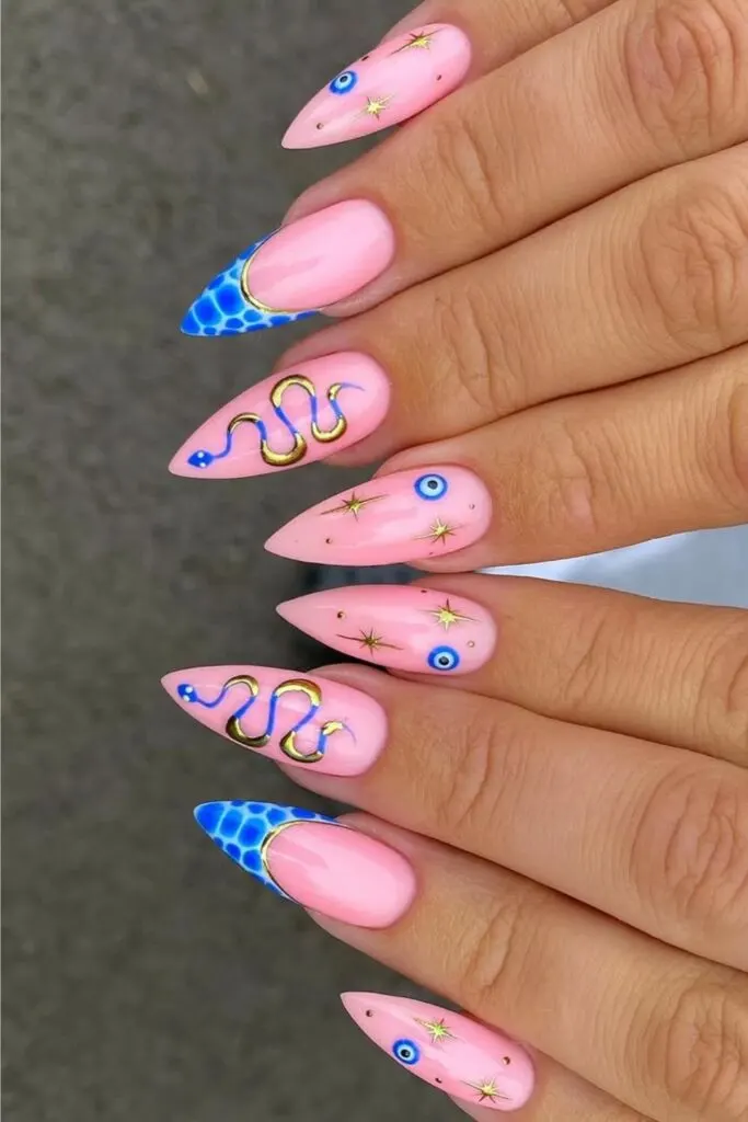 Pink nails with blue snake print tips and gold snake accents