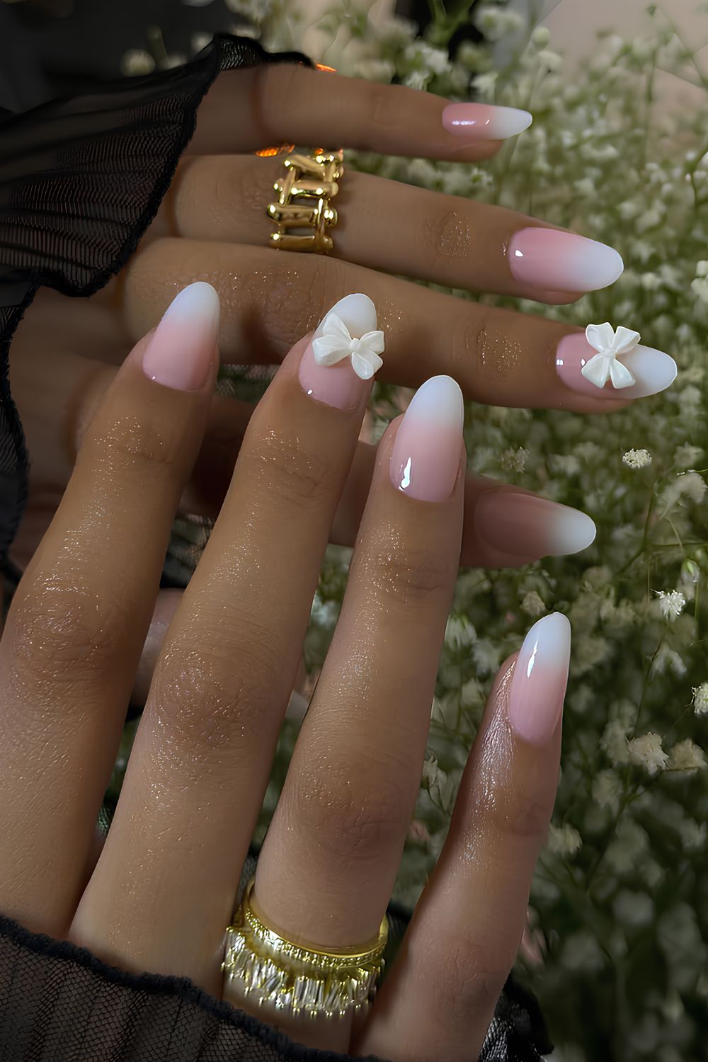 Pink and white ombre nails with 3D bows