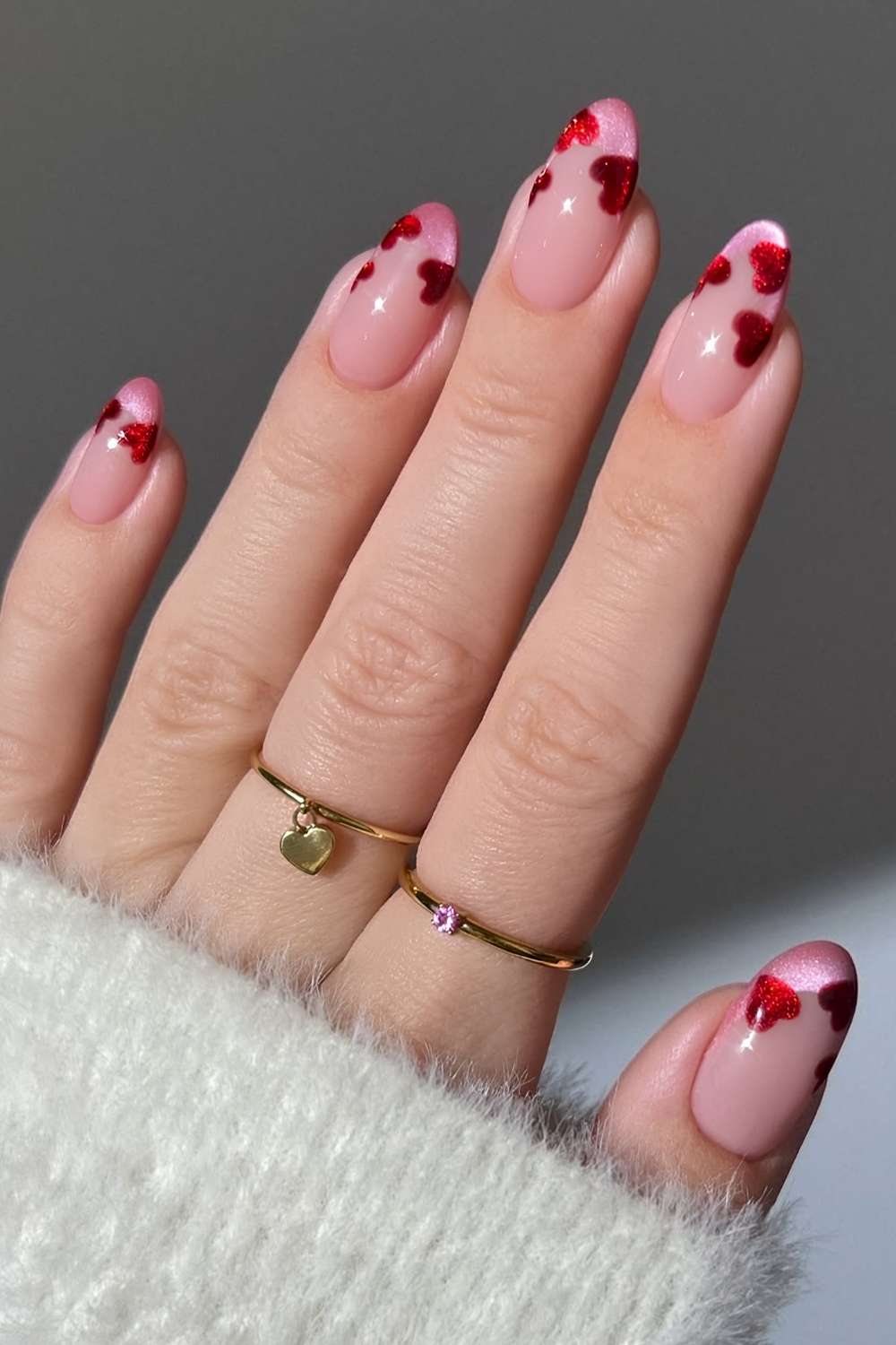 Pink cat eye French nails with red hearts