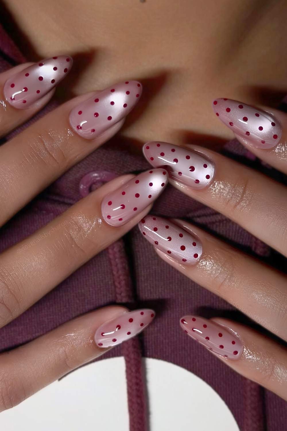Pink cat eye nails with polka dots