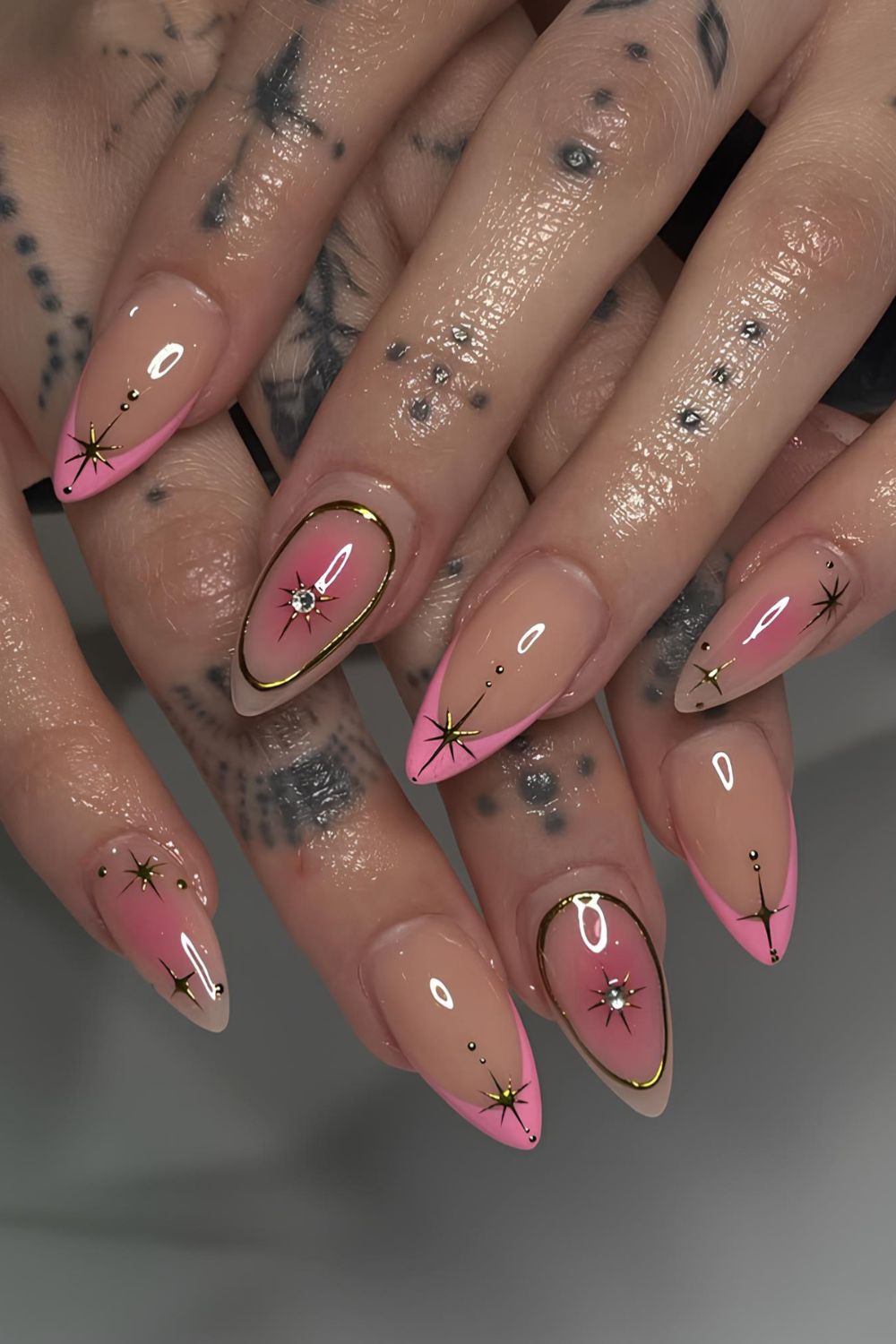 Pink celestial nails with metallic accents