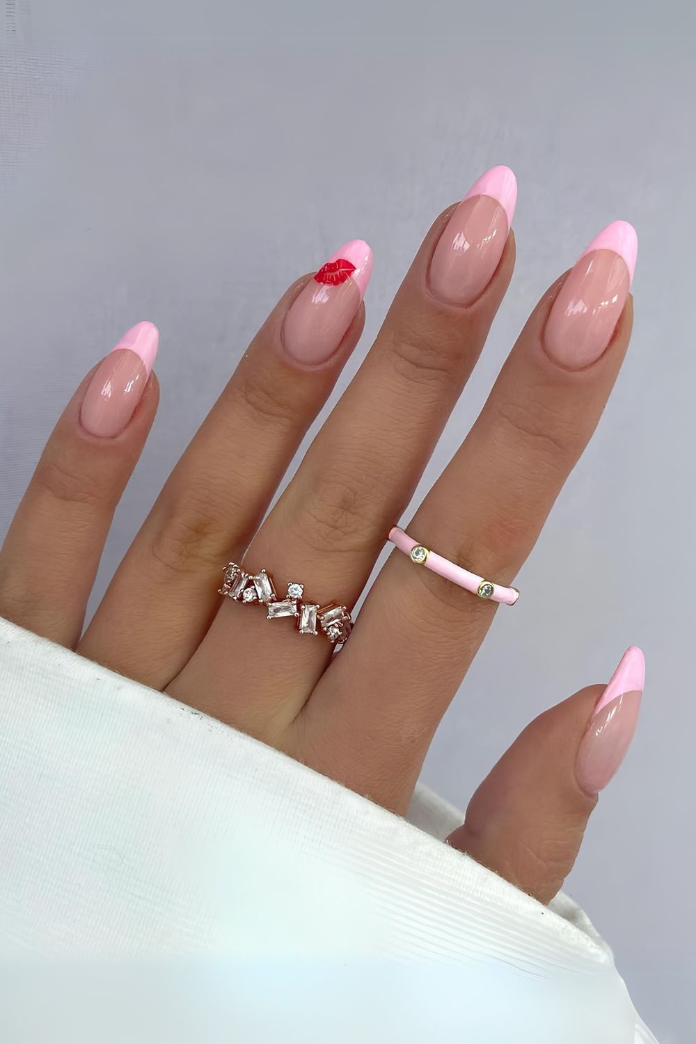 Pink french tips with a single kiss design