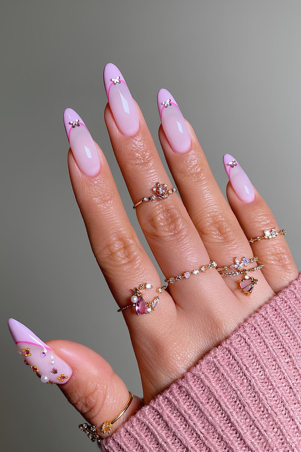 Pink nails with pink outline and crytsal accents