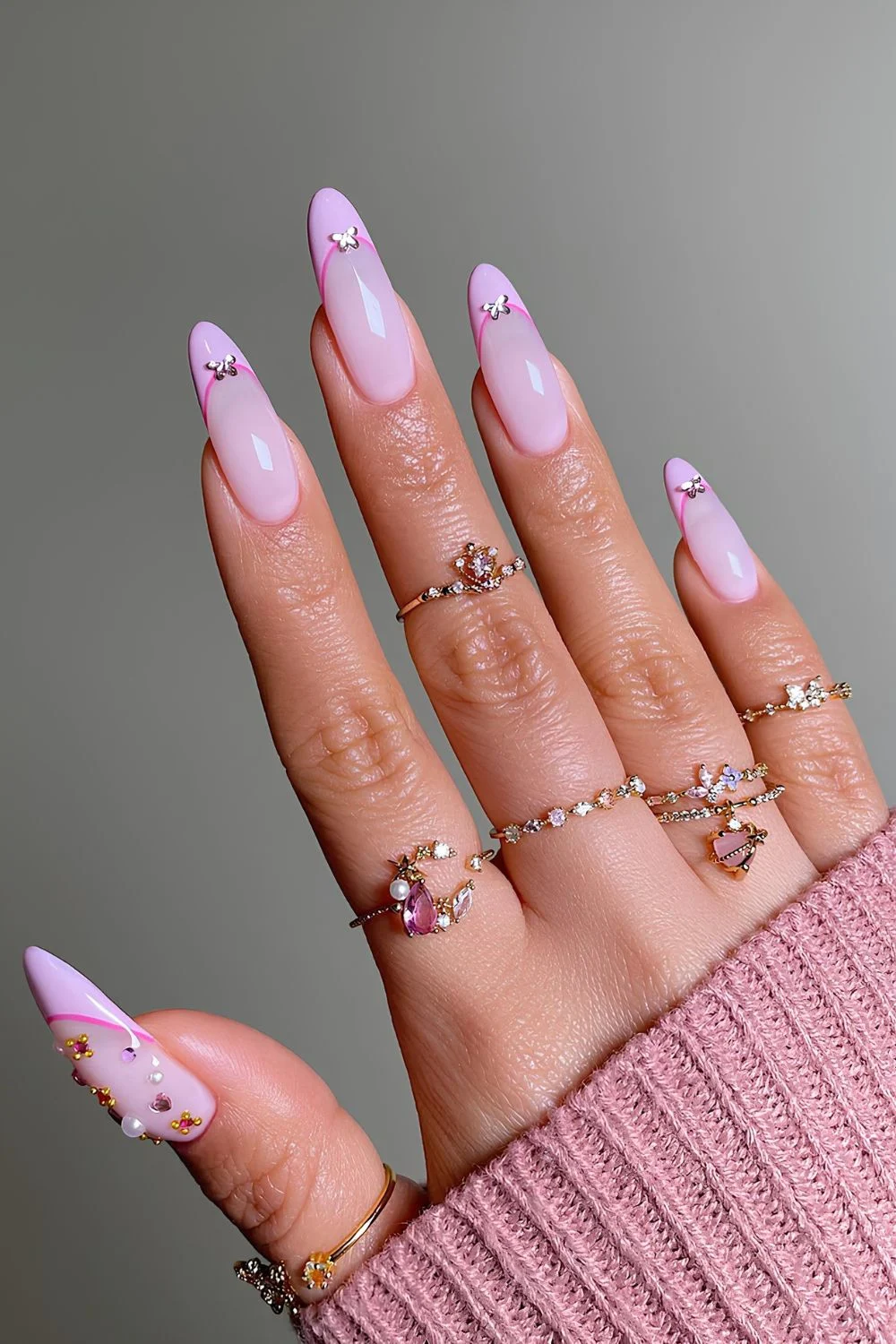 Pink nails with pink outline and crytsal accents