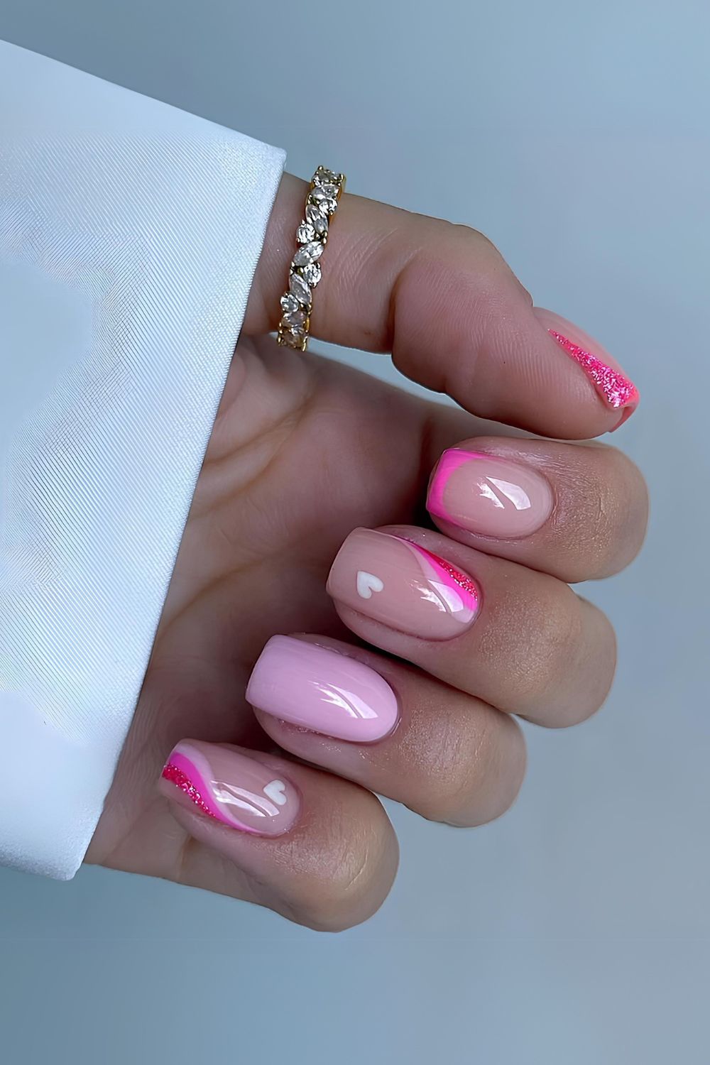 Pink nails with swirls and hearts