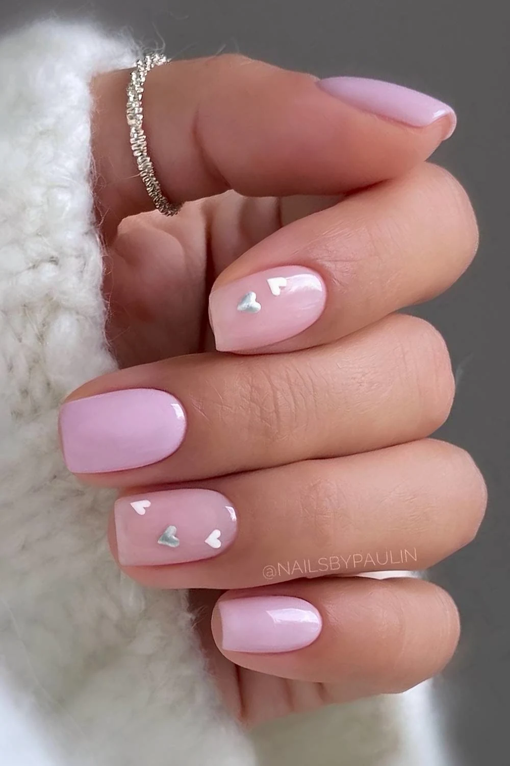 Pink nails with white and silver hearts