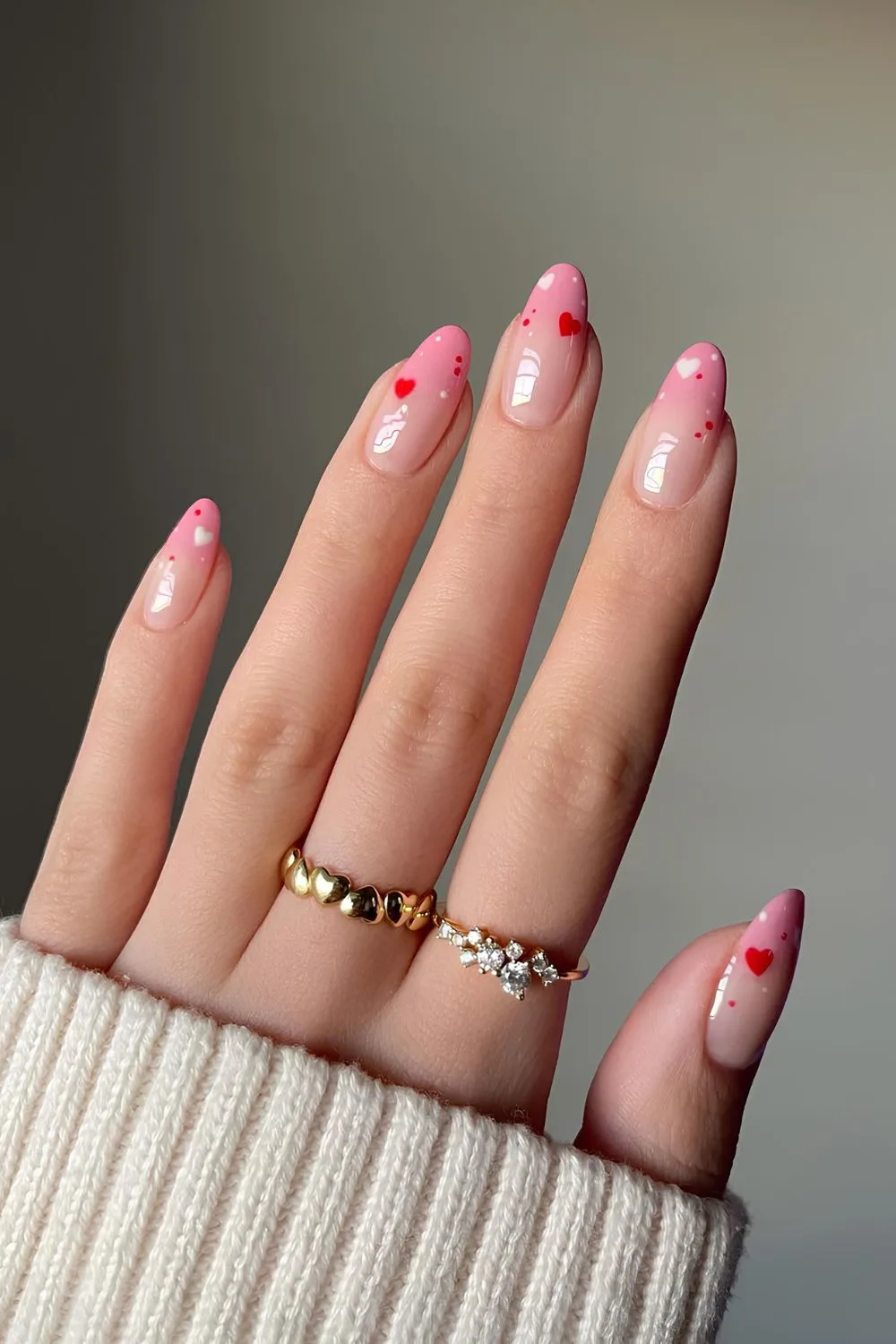 Pink ombre nails with tiny hearts on tips