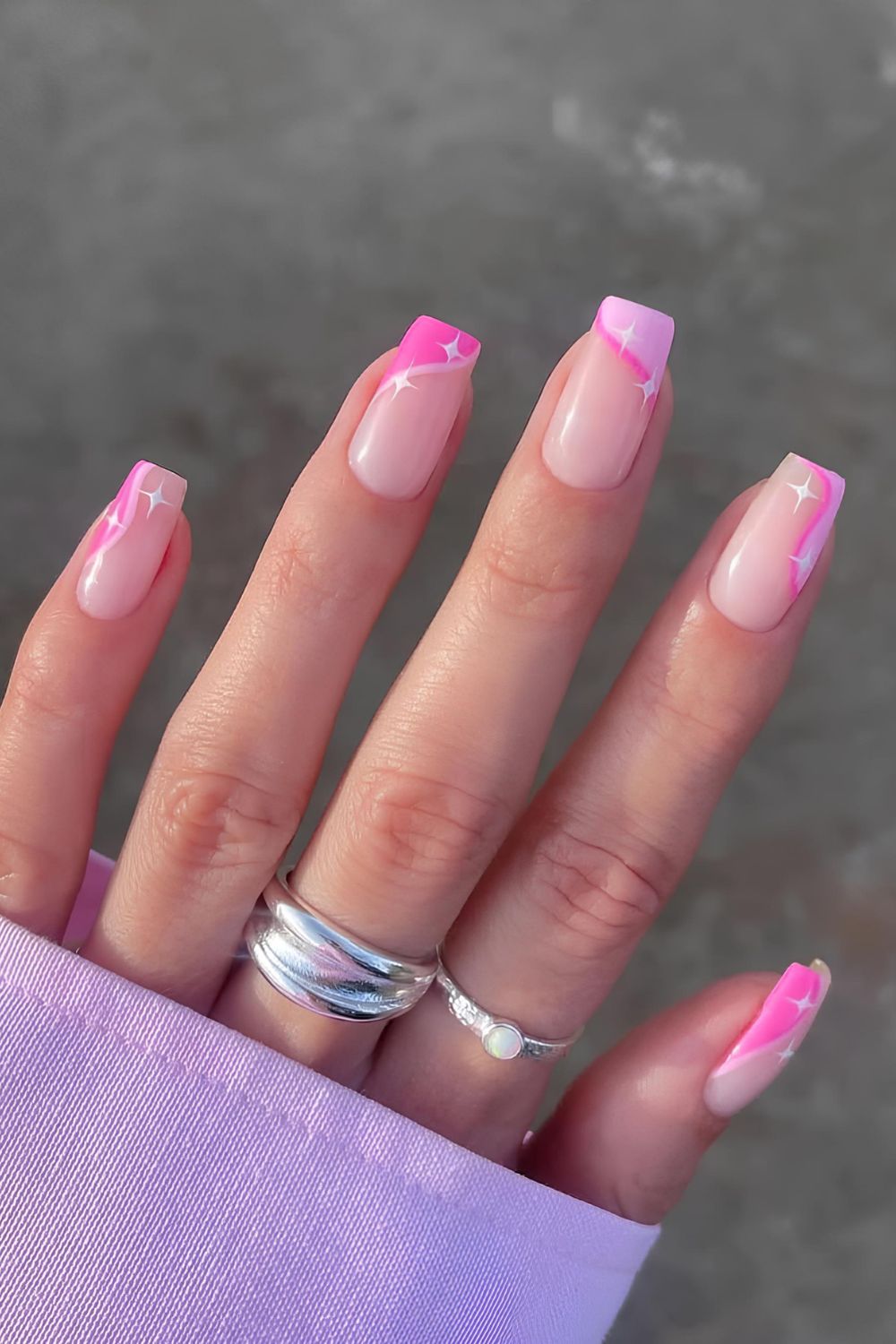 Pink side French tip nails with white star accents