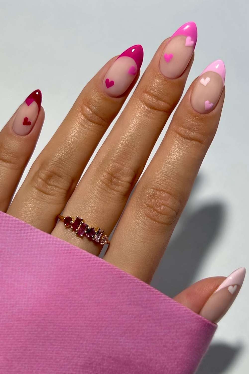 Pink skittle French manicure with accent hearts
