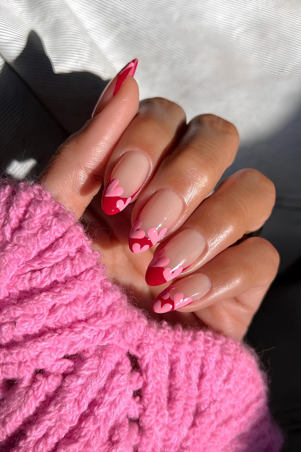 Red French manicure with pink hearts