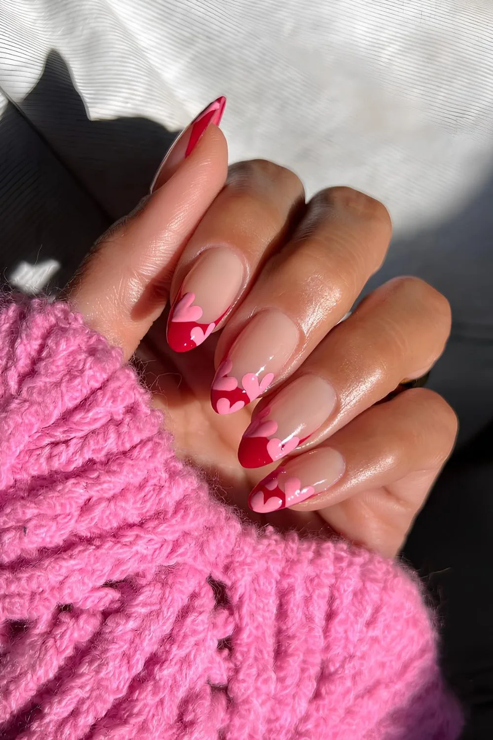 Red French manicure with pink hearts