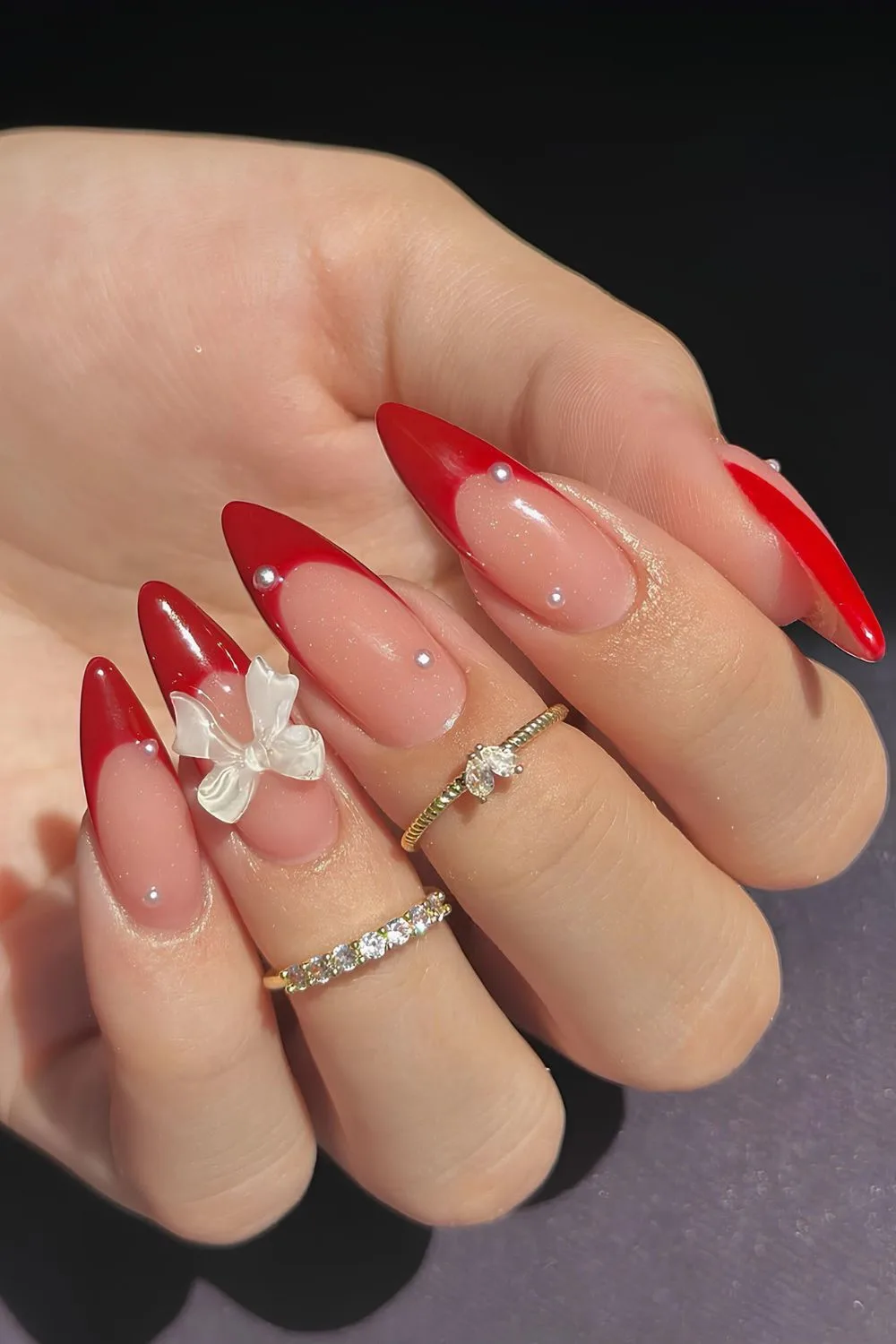 Red French nails with coquette bows