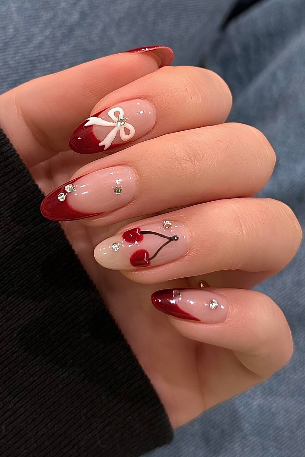 Red French nails with gems and cherry art