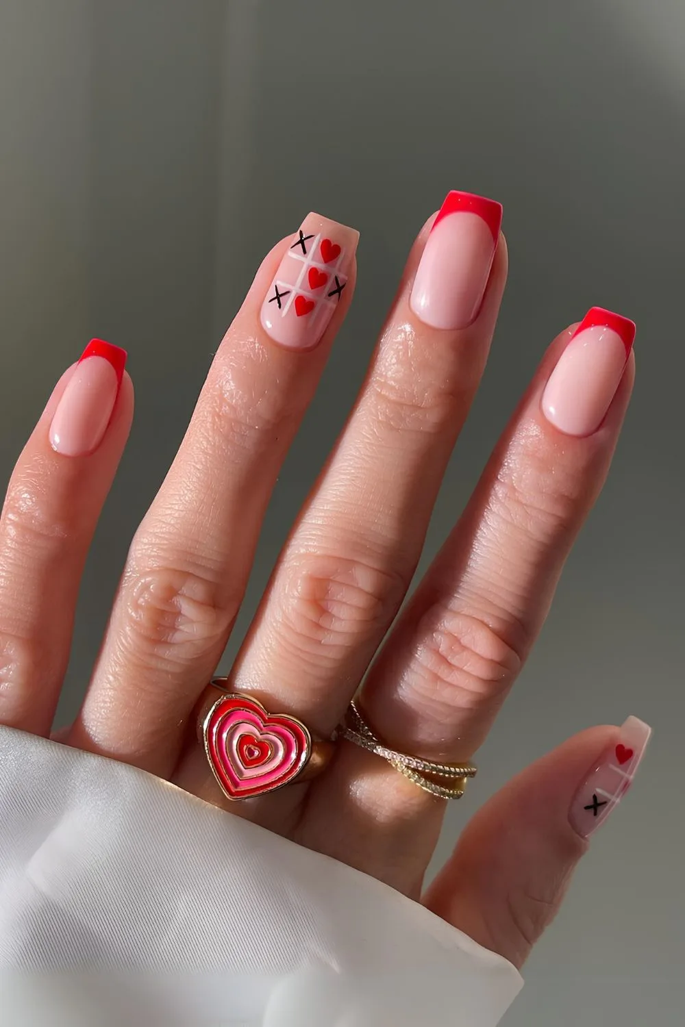 Red French nails with hearts and crosses