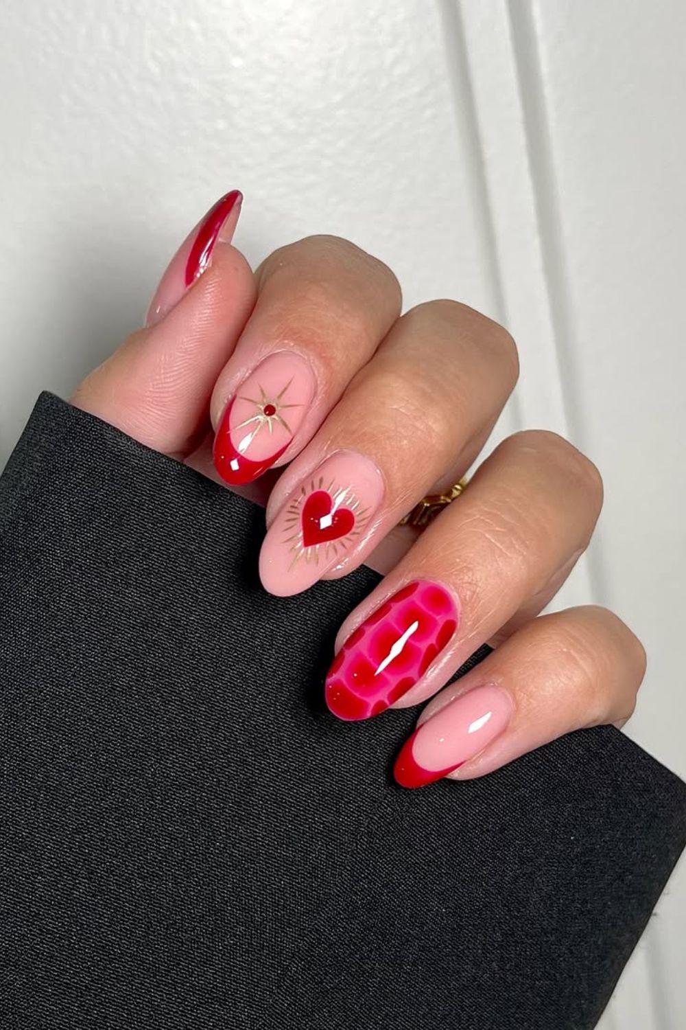 Red French tip nails with heart and chrome accents