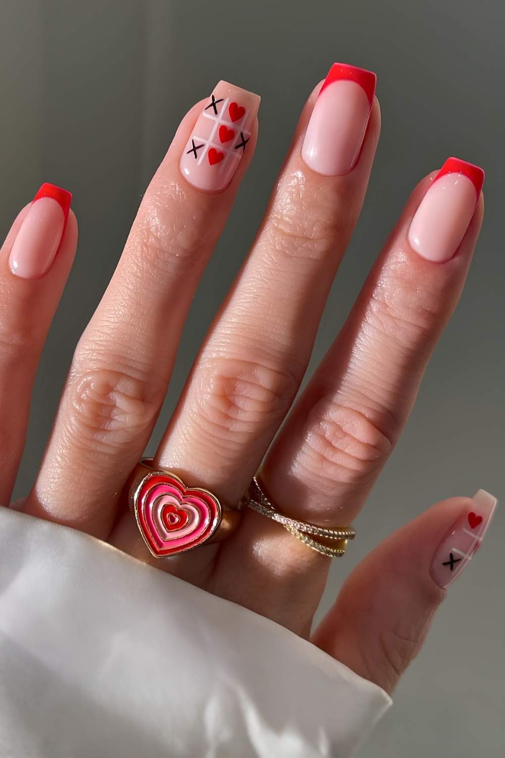 Red French tips with hearts and crosses art