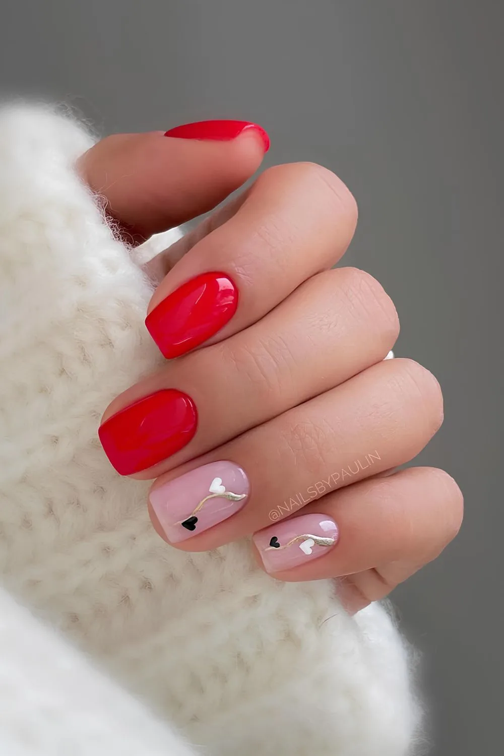 Red and pink mani with black and white hearts