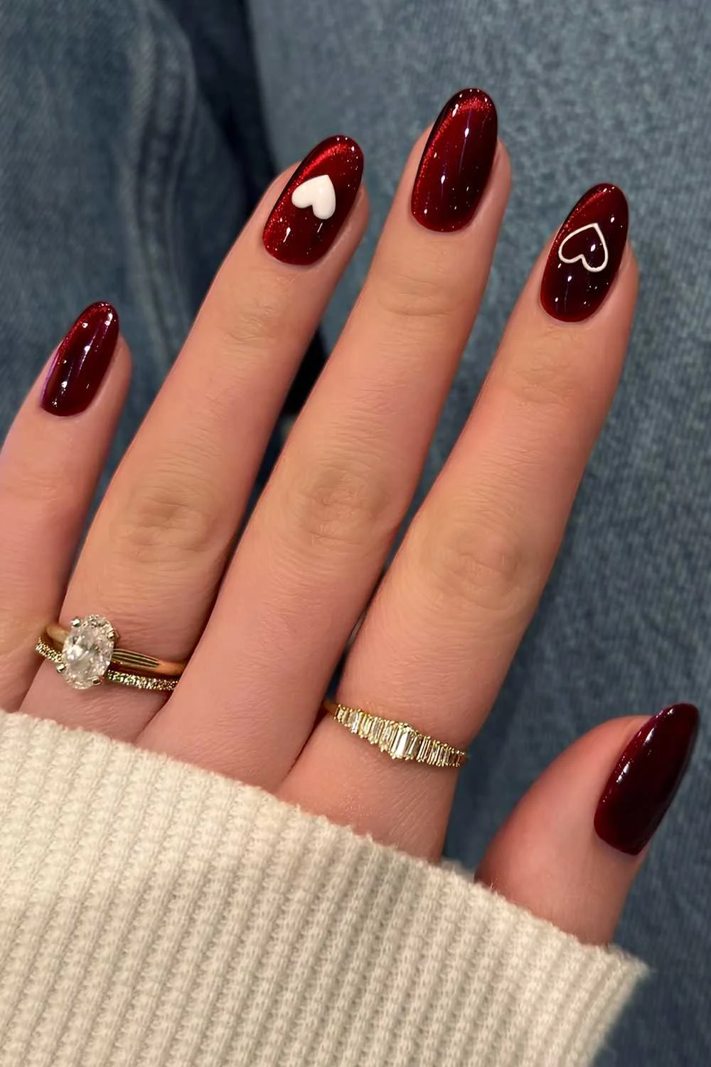 Red cat eye nails with accent hearts