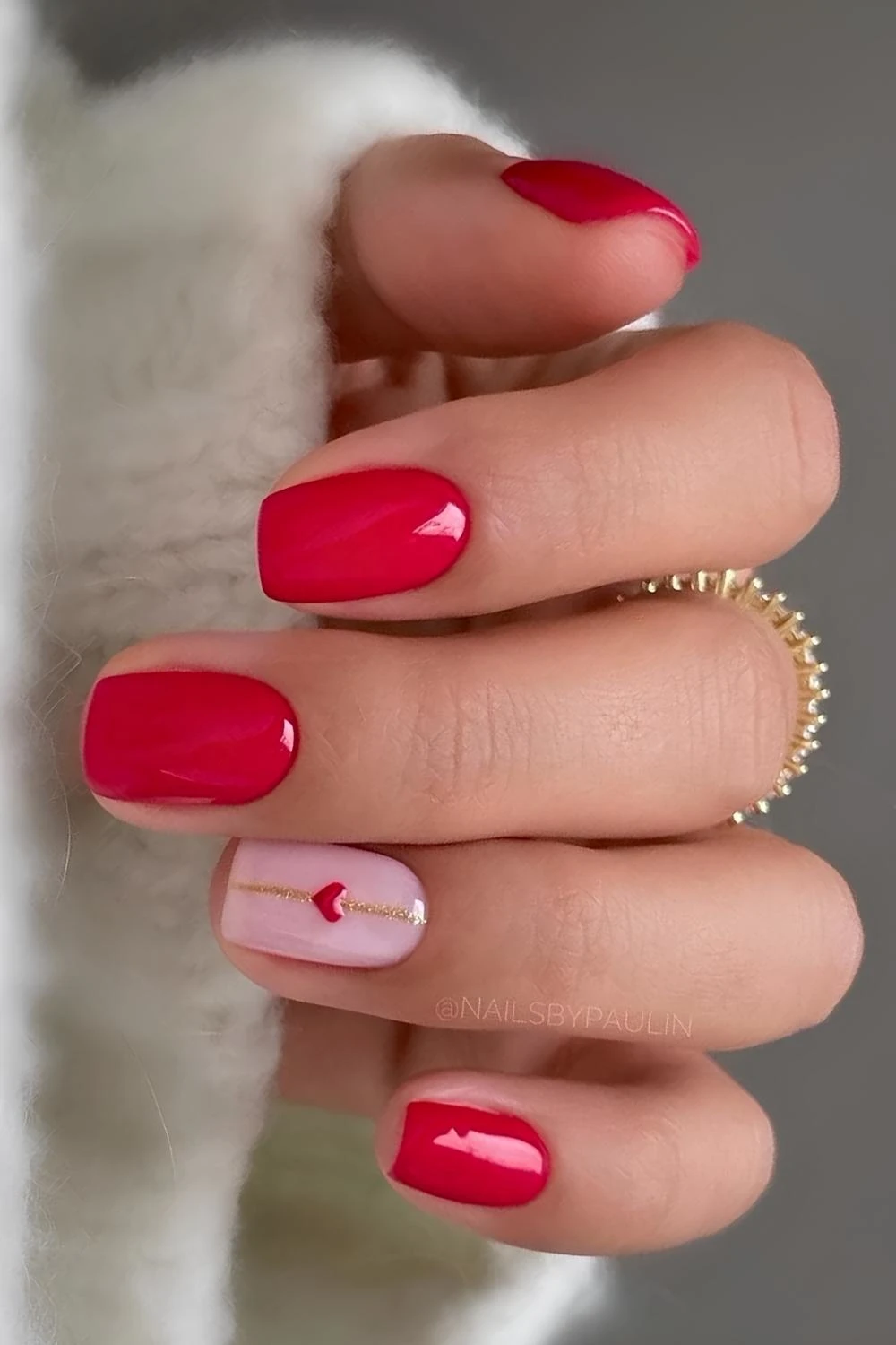 Red nails with hearts and gold glitter