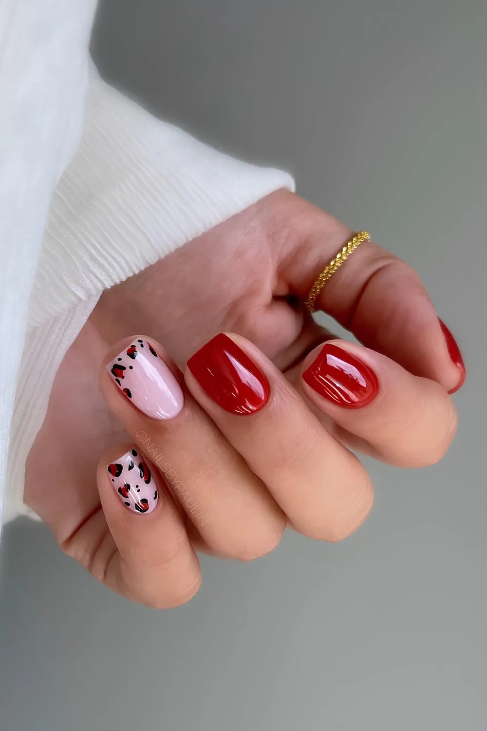 Red nails with leopard print accent