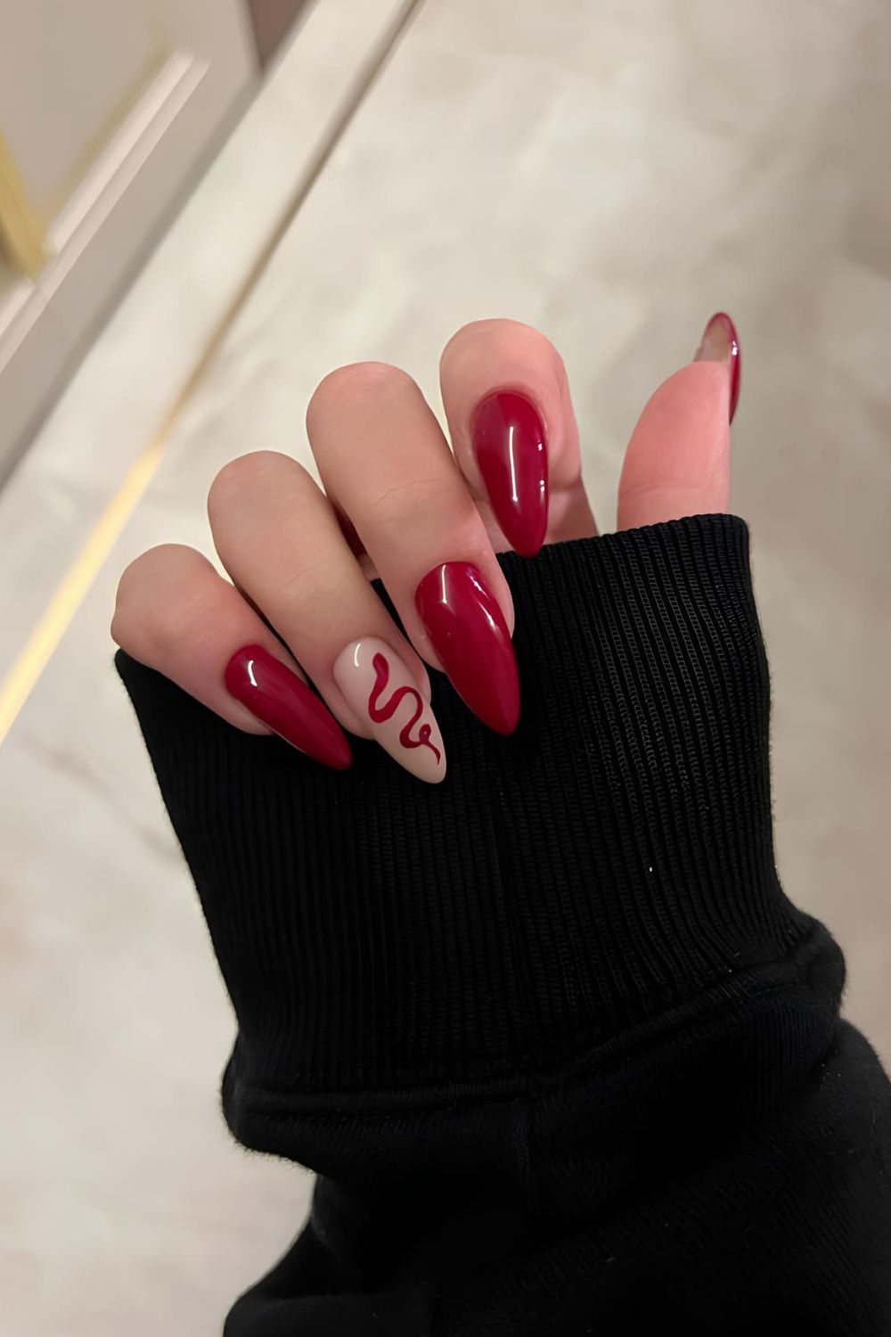 Red nails with red snake accent