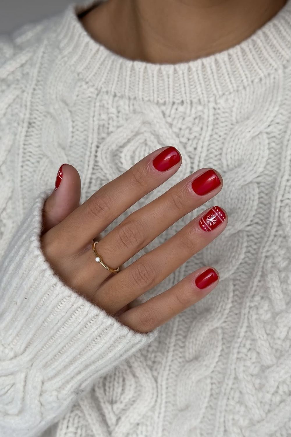 Red nails with snowflake accent