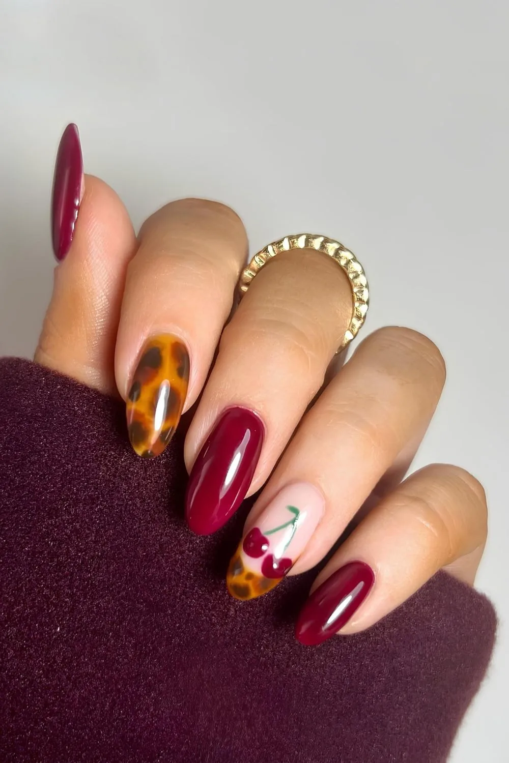 Red nails with tortoise shell and cherry accents