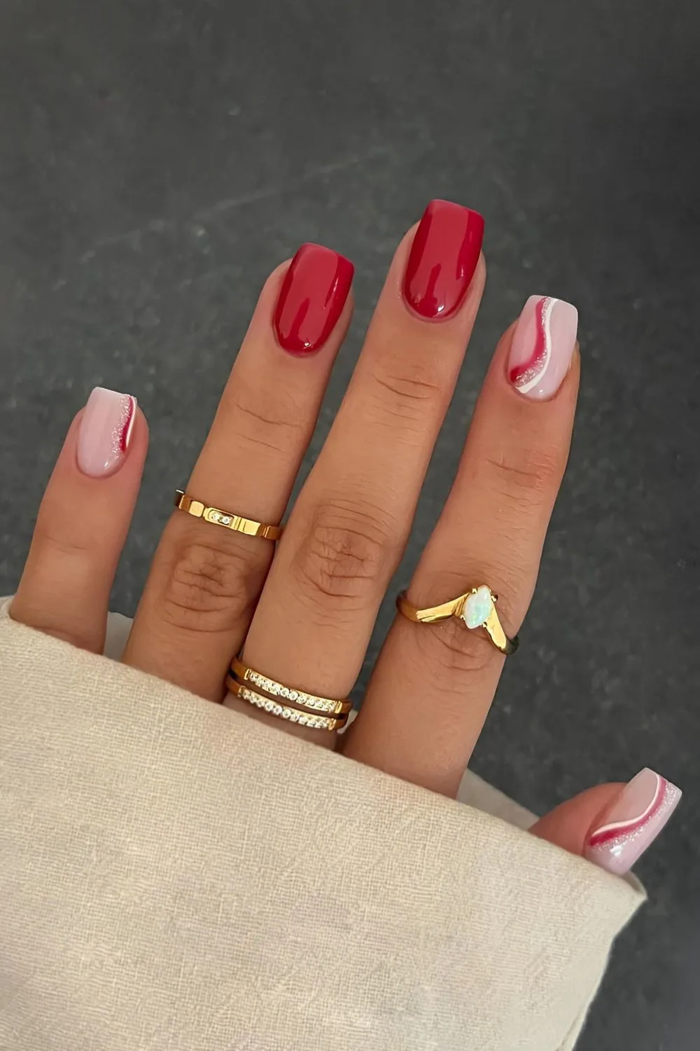 Red nails with white and swirl accent