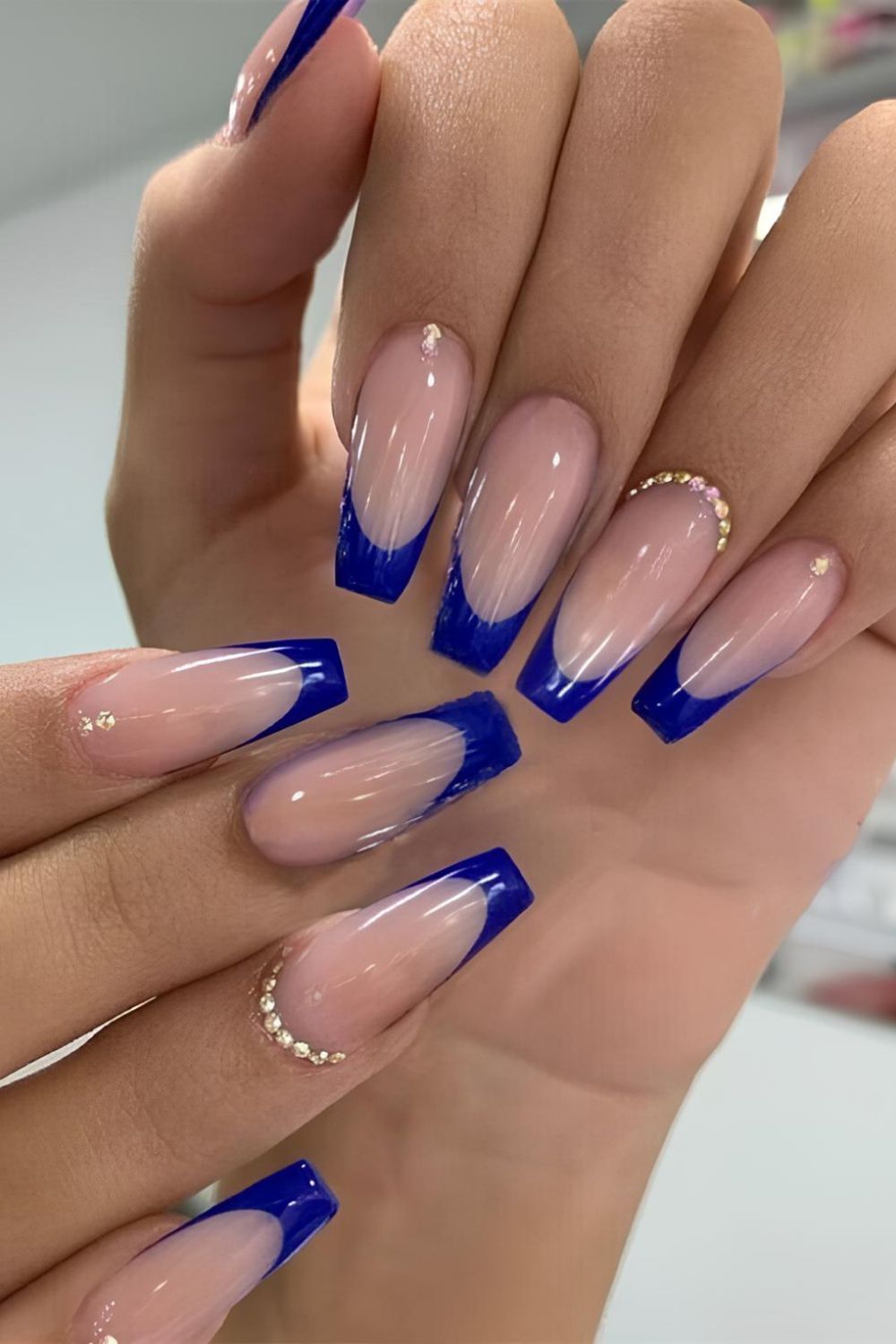 Royal blue French tip nails with crystal accents