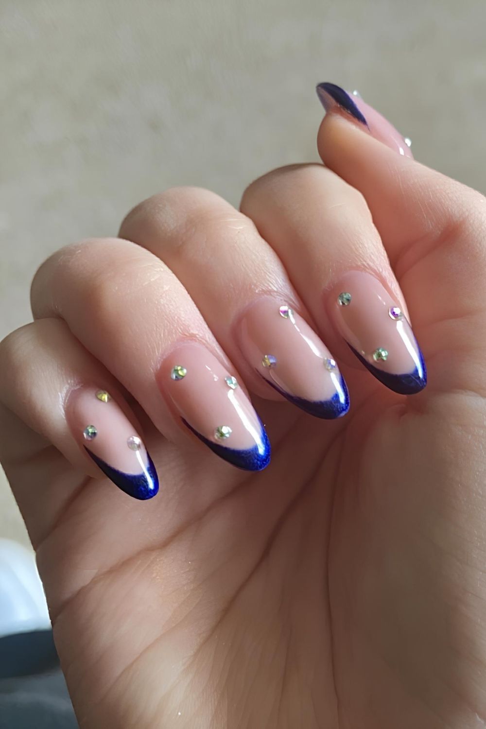 Royal blue French tip nails with rhinestones