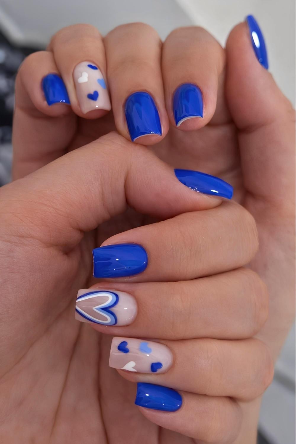 Royal blue manicure with accent hearts