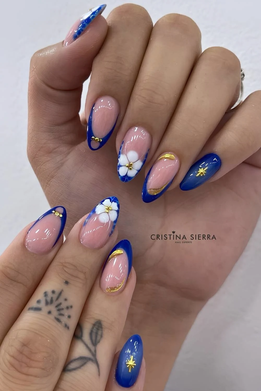 Royal blue nails with gold and floral details