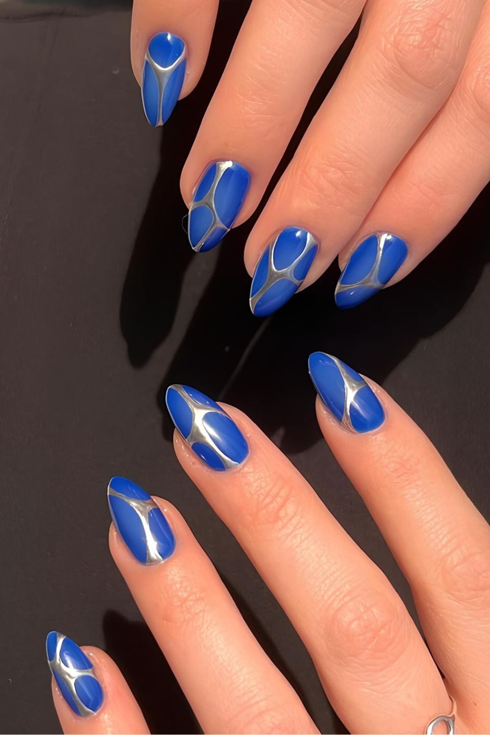 Royal blue nails with silver chrome line accents