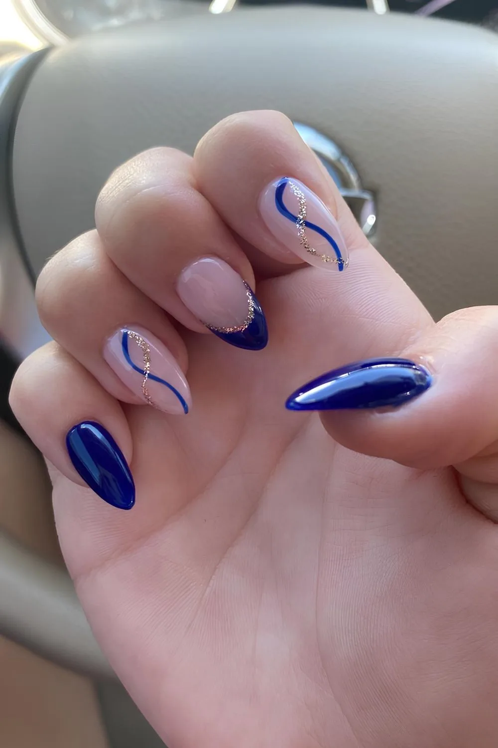 Royal blue solid and French tip nails with glitter swirl