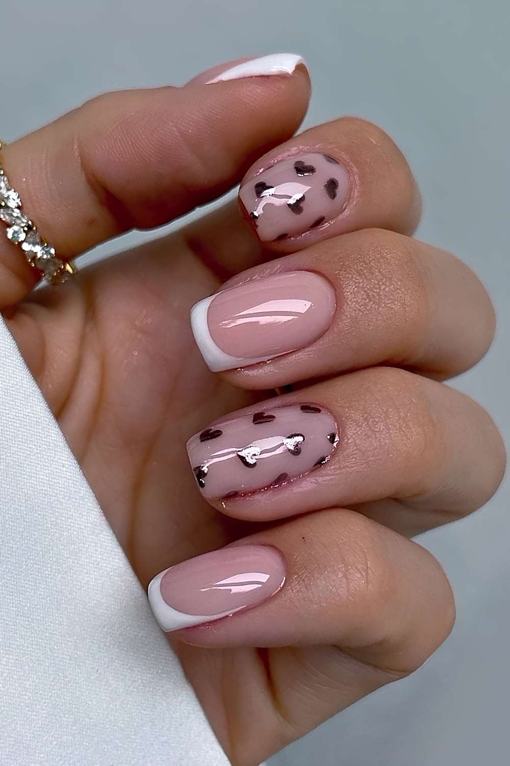 Short white french mani with metallic hearts