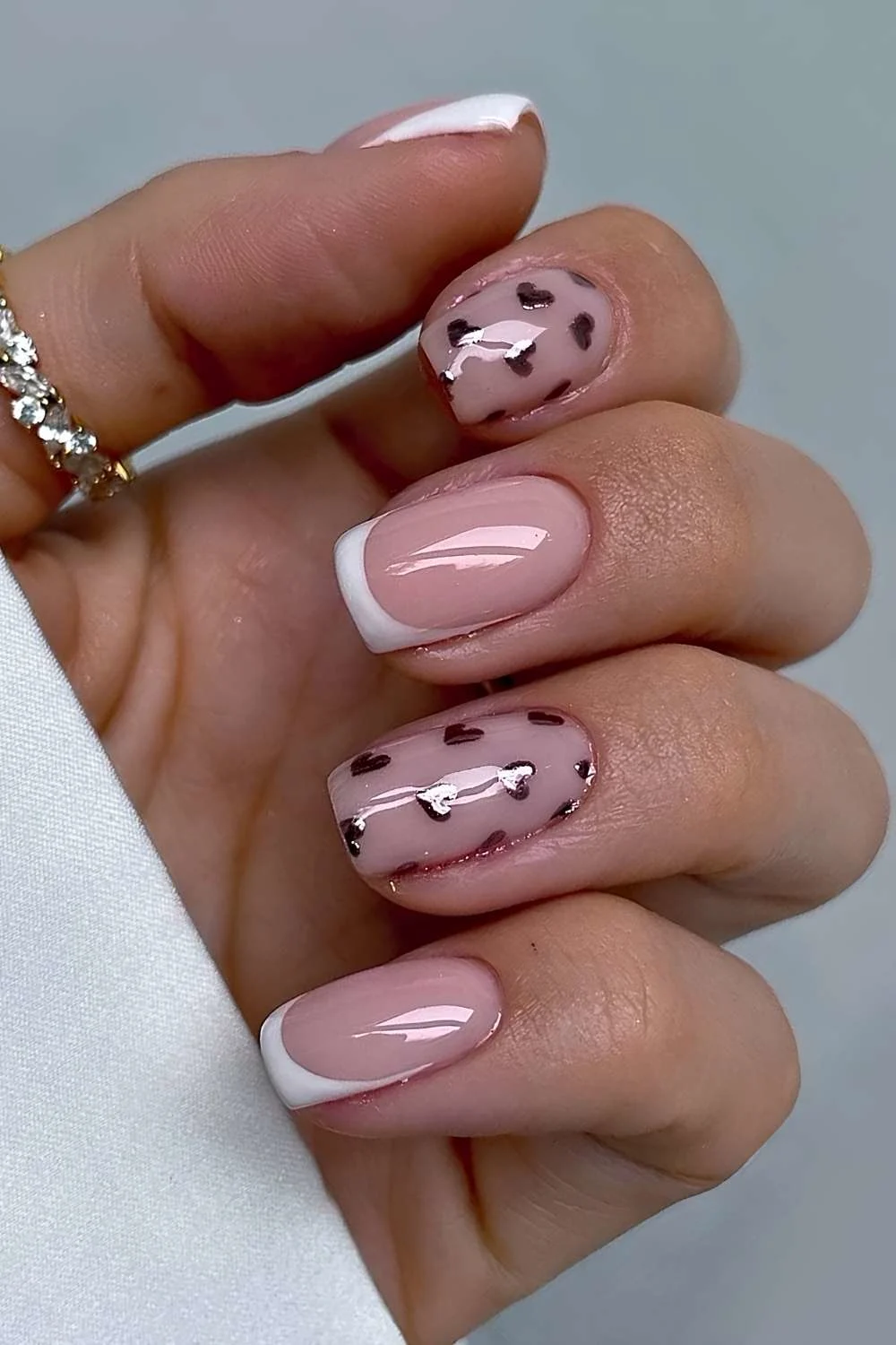 Short white french mani with metallic hearts