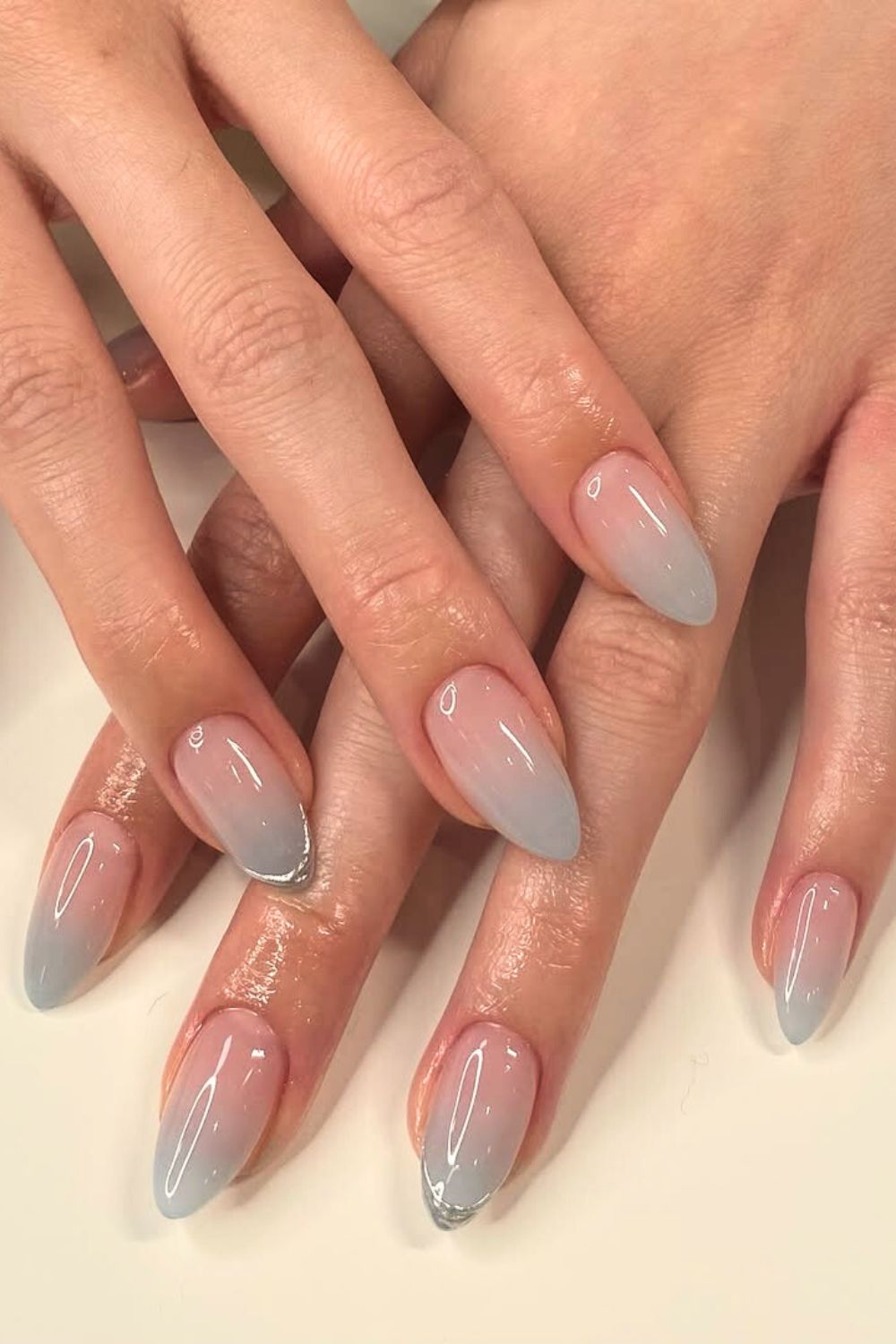 Soft blue ombre nails with silver chrome accent