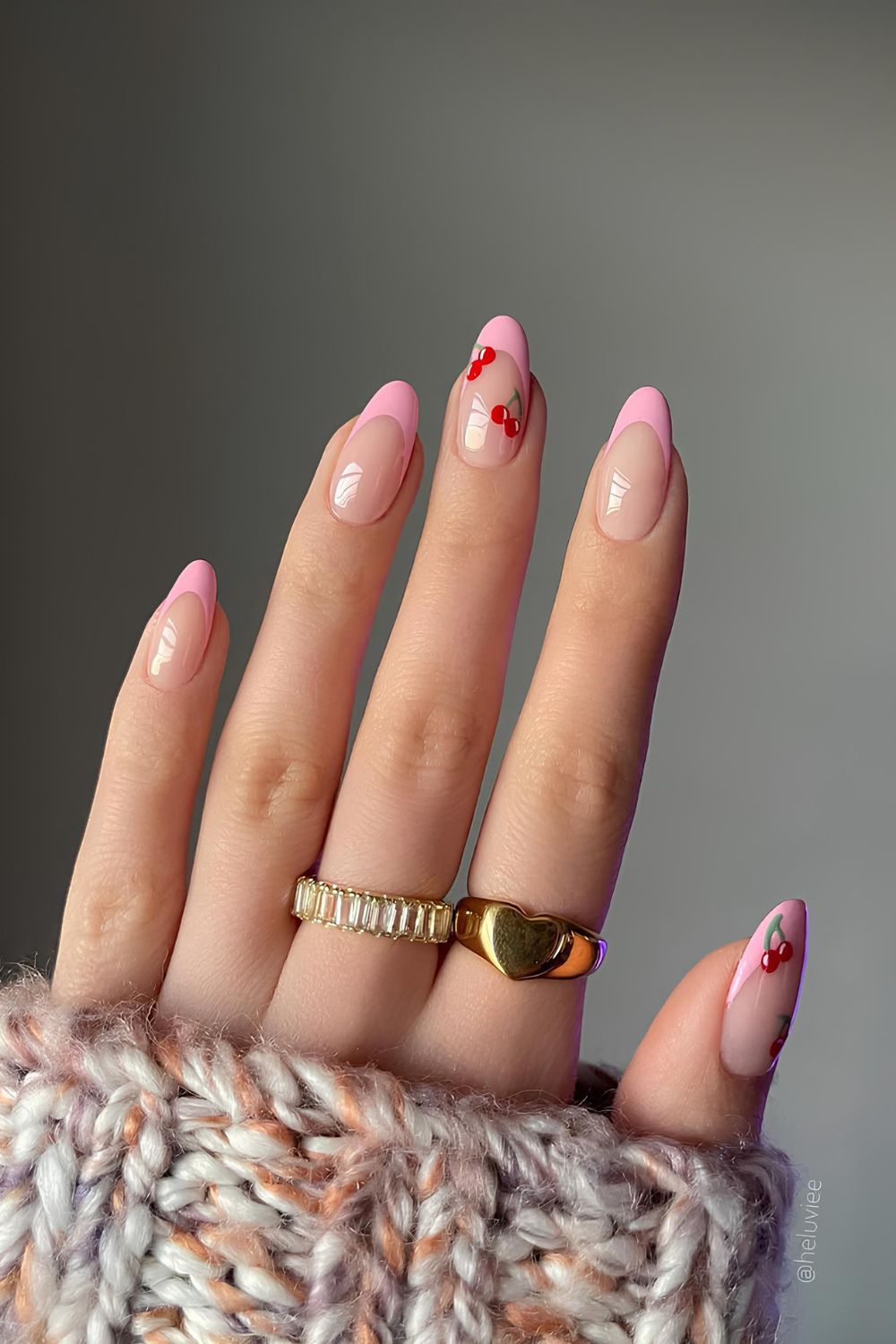 Soft pink French tip nails with cherry accents