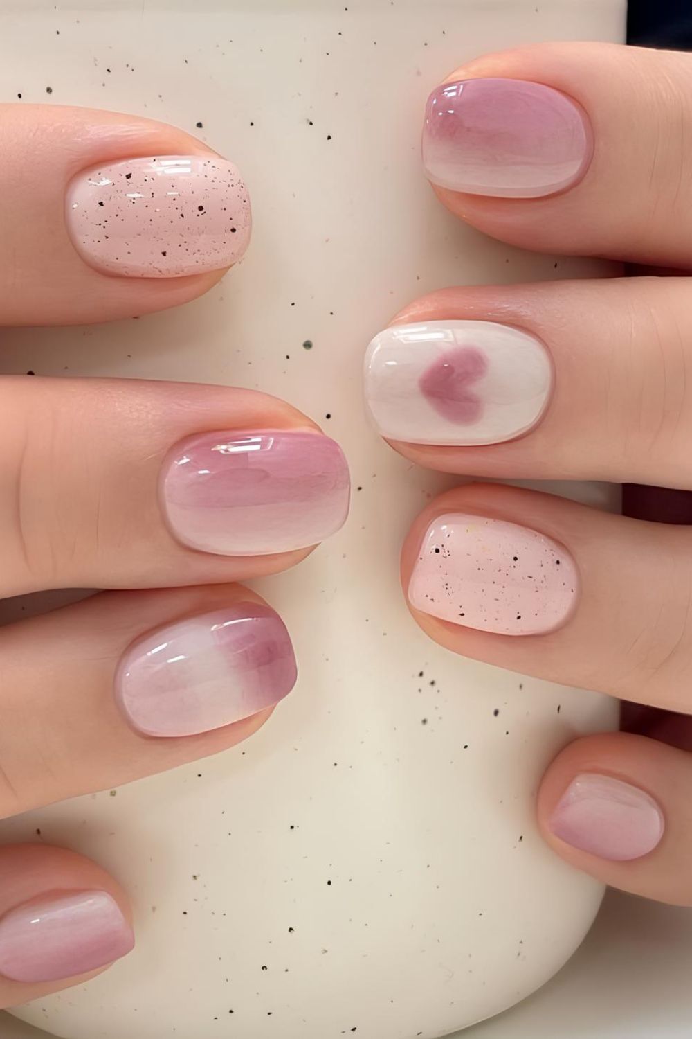 Soft pink and white ombre nails with heart accent