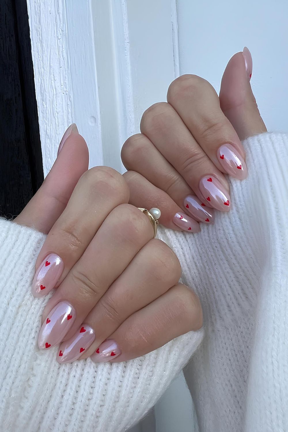 Soft pink chrome nails with red hearts