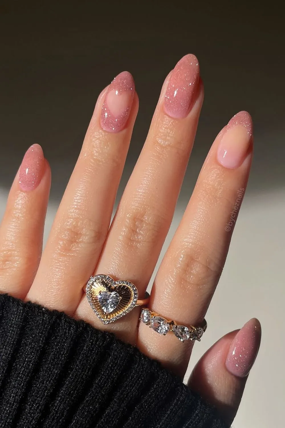 Soft pink glitter nails with negative heart space accent