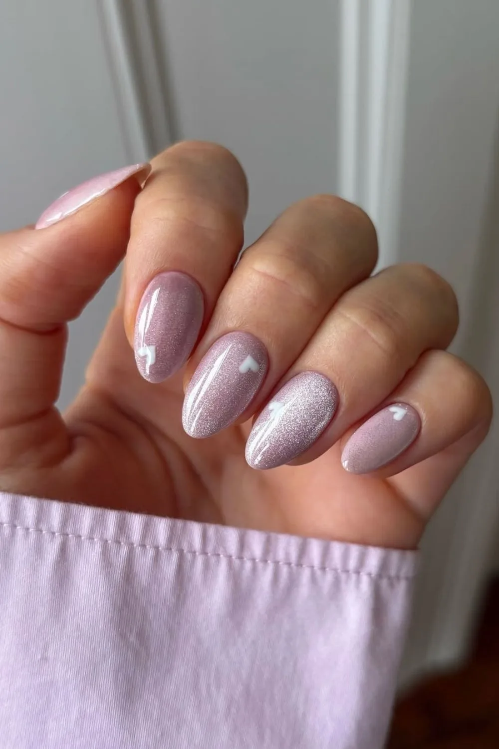 Soft pink velvet nails with white heart accents