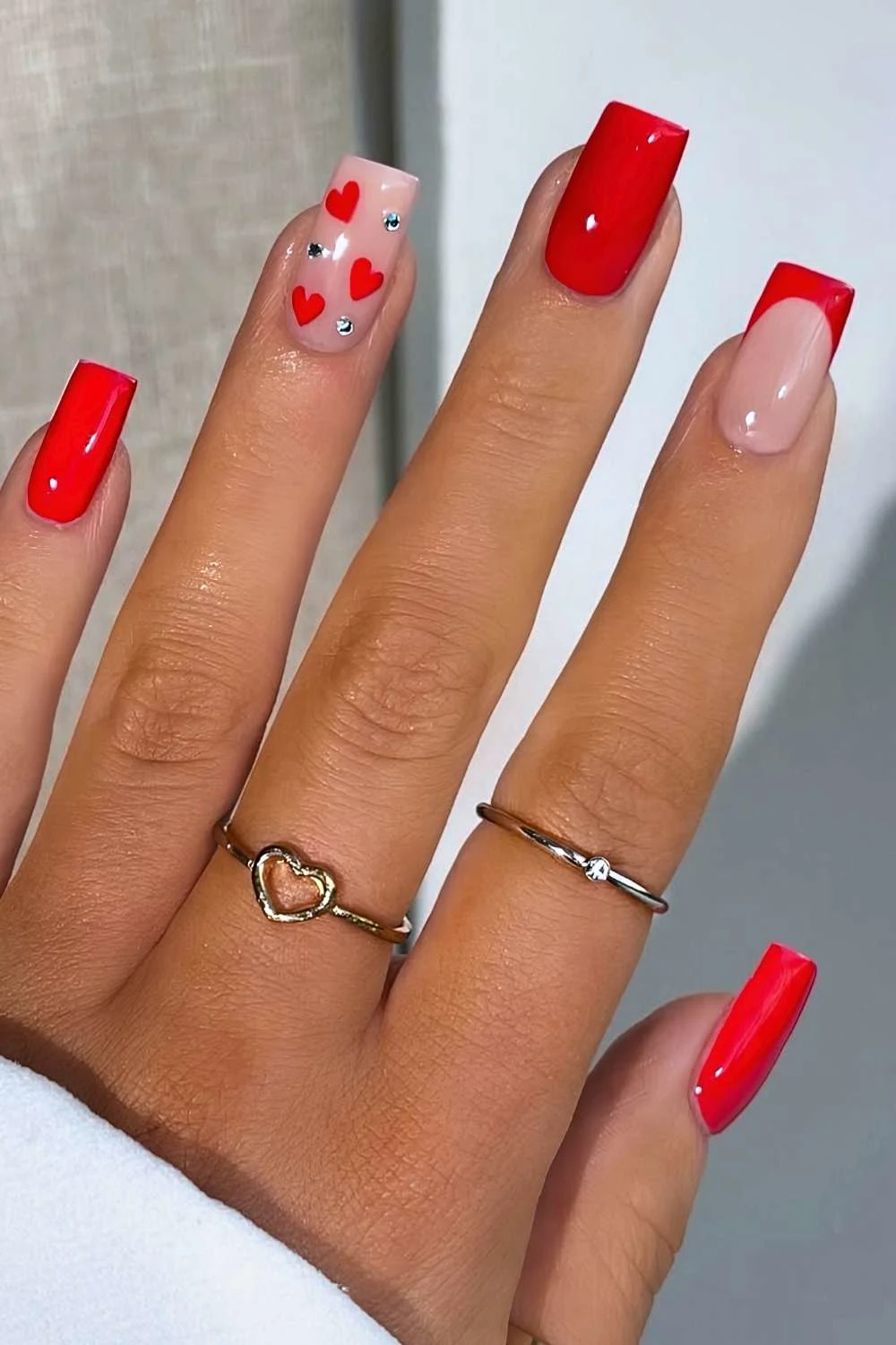 Square red nails with gems and hearts