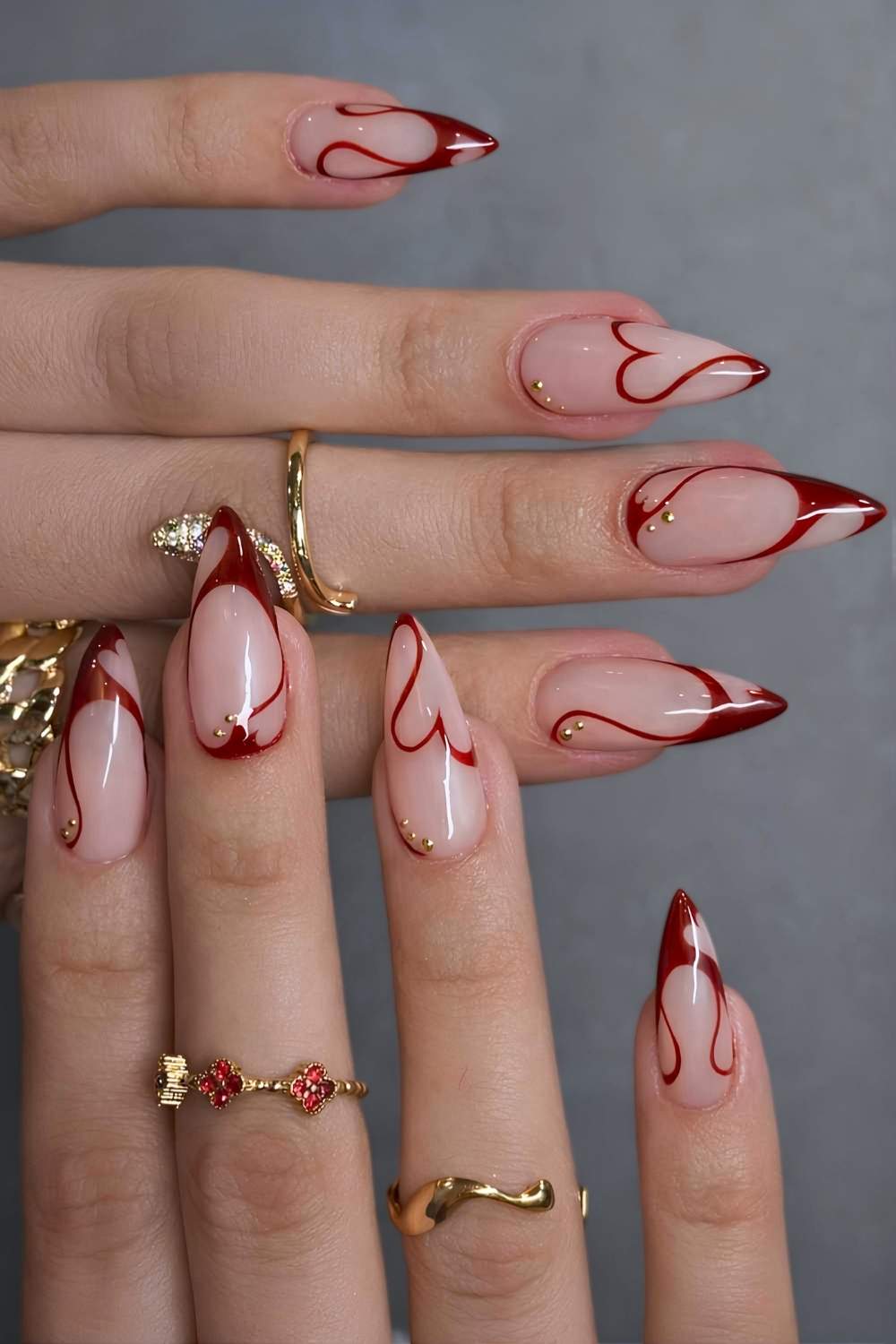 Swirly red French mani with abstract hearts