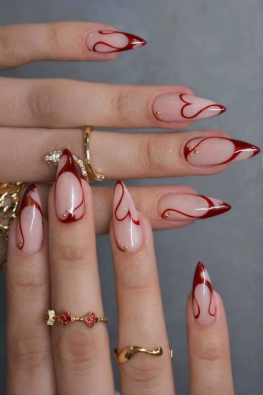 Swirly red French mani with abstract hearts