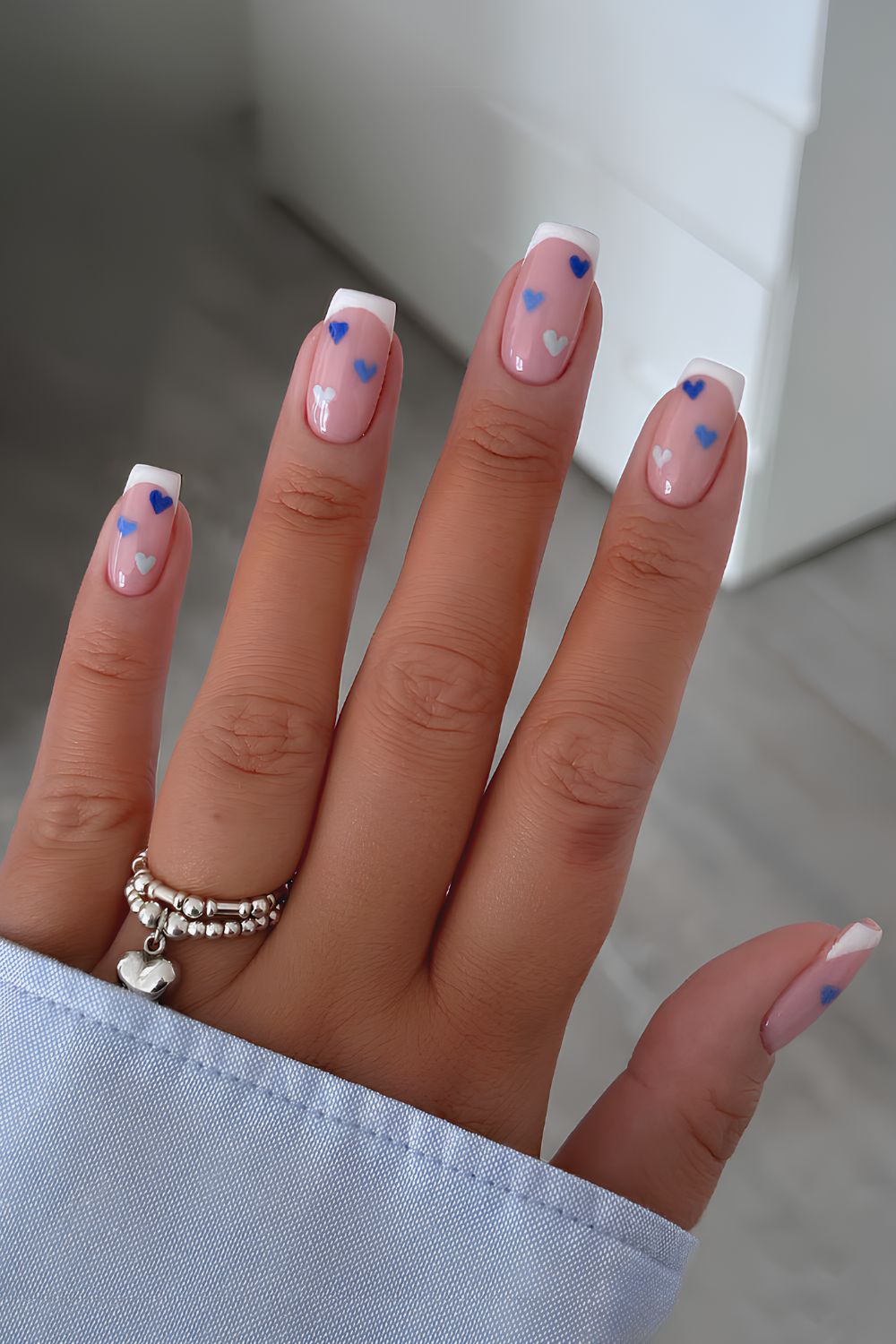 White French mani with blue hearts