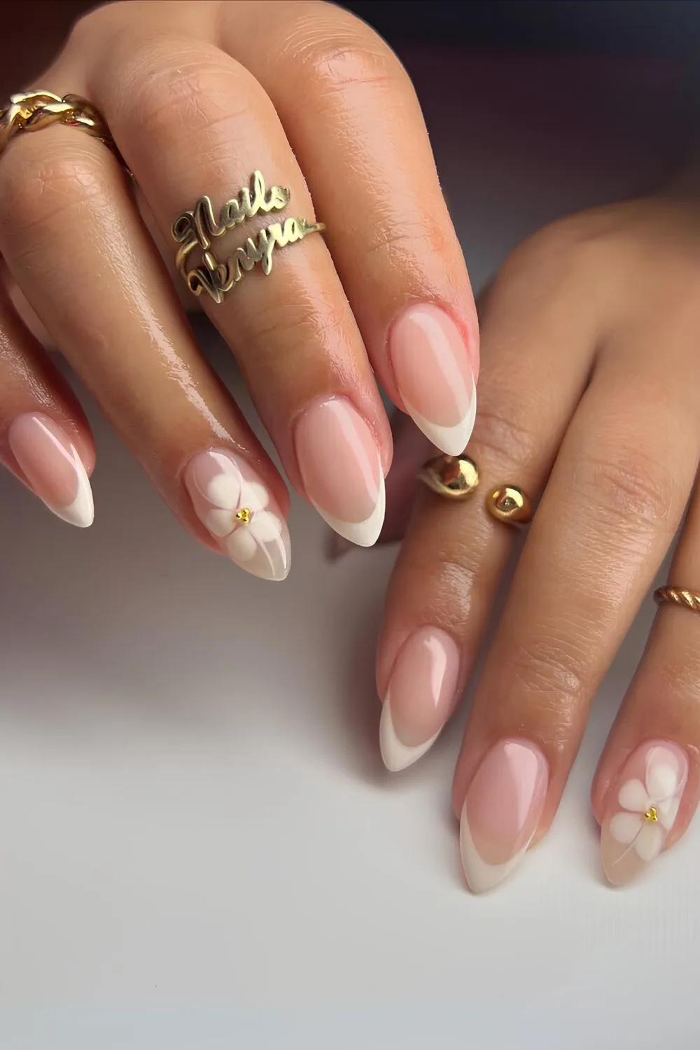 White French nails with blooming flower accent