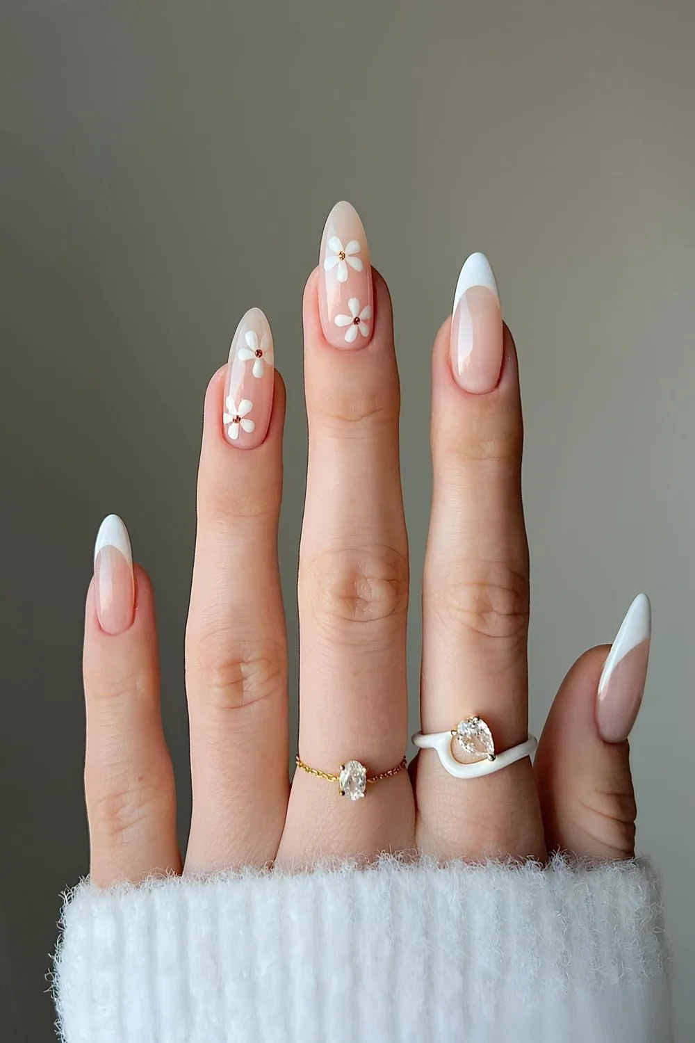 White French nails with daisy accents