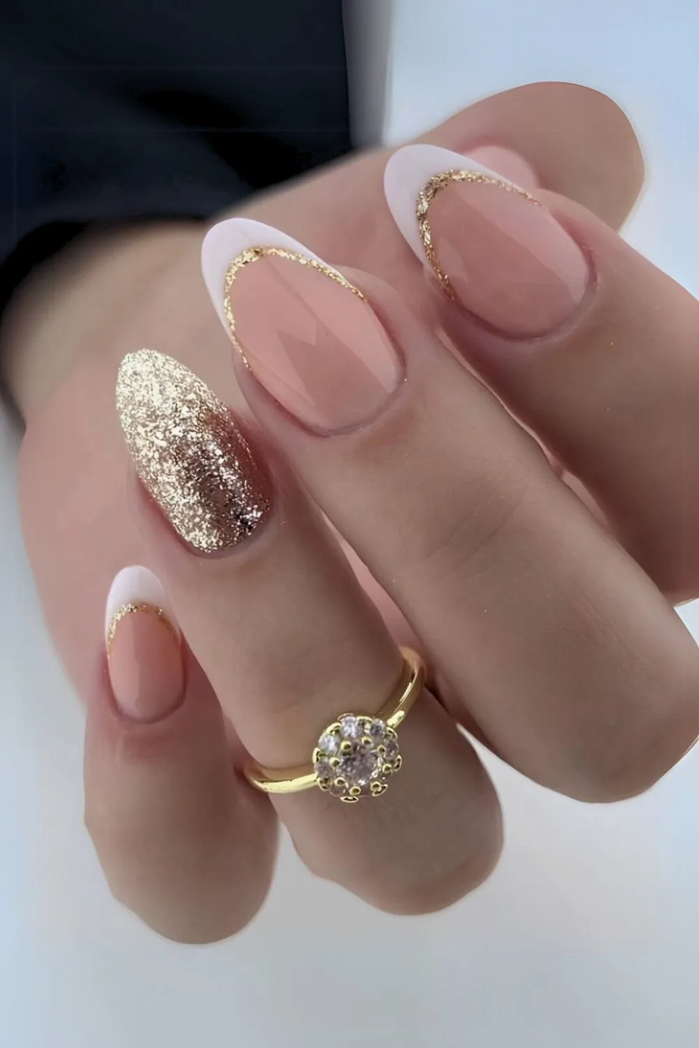 White French nails with gold glitter accents